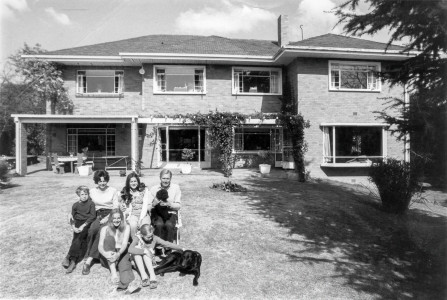 The Christmas Photo: Page Woods with Drydie in front of Hume Road house. Oscar dog, and Yoko on Drydie's lap Page Woods with Drydie